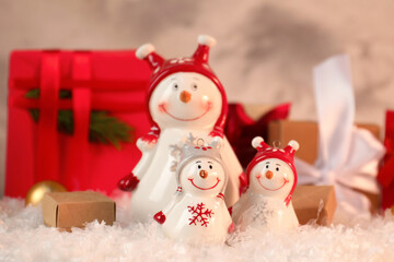 Funny snowmen figures and Christmas decor on artificial snow