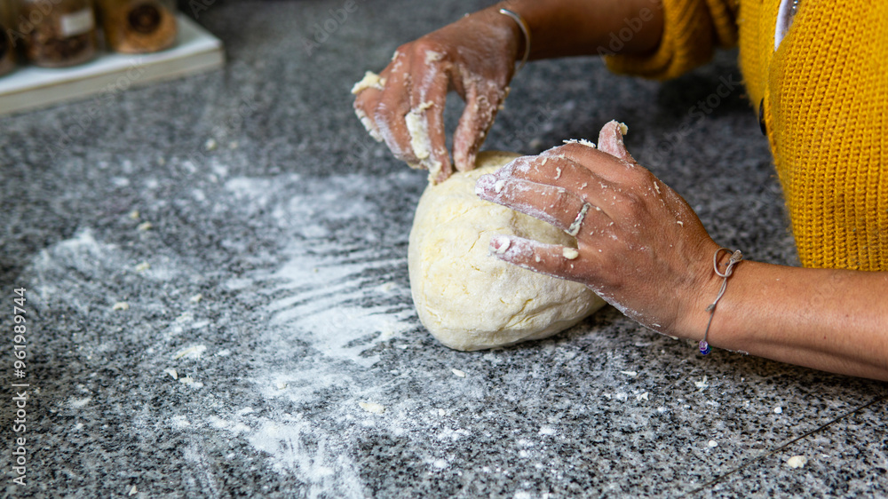 Wall mural close view of woman hands kneading dough in a kitchen counter for homemade fresh pasta