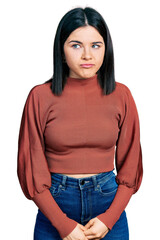 Fototapeta premium Young brunette woman with blue eyes wearing elegant sweater depressed and worry for distress, crying angry and afraid. sad expression.