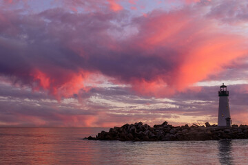 Vibrant twilight skies over Breakwater (Walton) Lighthouse via Seabright Beach. Santa Cruz, California, USA.