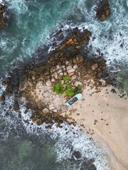 Stunning aerial view of Mirissa, Sri Lanka: a tropical paradise with palm-fringed beaches, vibrant blue waters, and picturesque coastline under clear, sunny skies.