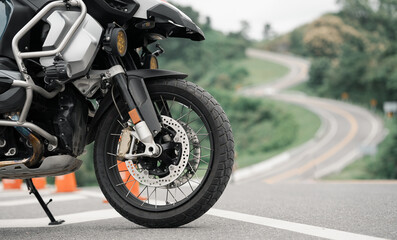 Obraz premium Part of a touring bike Driver's bike. Parking on the street during the day with good light. And there is space to copy space for text. Road motorcycle touring. motorcycle in a sunny motorbike on th 