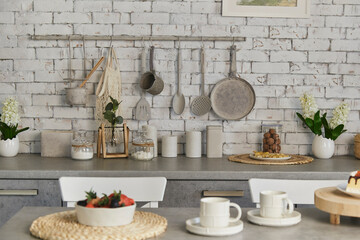 Contemporary kitchen scene featuring fruits and berries and coffee for two. Selective focus