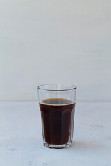 American glass of black coffee on white background. Hot espresso coffee glass isolated on white table. copy space
