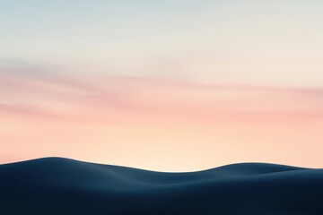 Obraz premium A Silhouetted Sand Dune Against a Pale Pink Sky