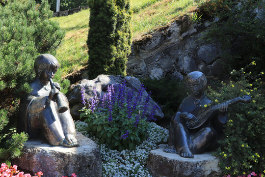 Statues of children playing instruments in Swiss mountain village