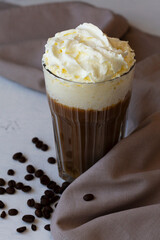 close-up of coffee cocktail in American glass with whipped cream on dark background. Alcoholic or non-alcoholic cocktail with liqueur, whiskey, white cream. copy space. vertical