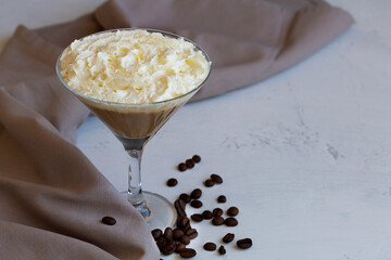 chocolate mousse with whipped cream. coffee cocktail in martini glass with whipped cream on dark background. Alcoholic or non-alcoholic cocktail with liqueur, whiskey, white cream. copy space.