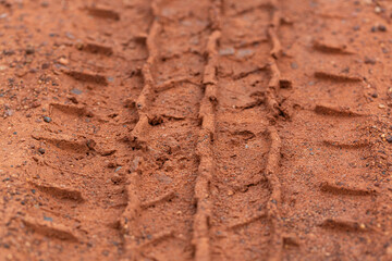 Close-up of car tire pattern on the ground,Close up of tire track or tire tread left behind in the mud or dirt.