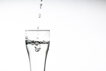 Pouring water into a glass on a white background. Close-up image,Glass of drinking water isolated on white background