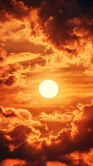A beautiful sun rising between clouds in a close-up of warm tones. Sun partially obscured by clouds in a natural landscape.