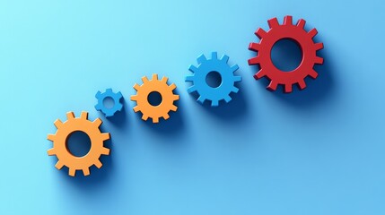 Colorful gears arranged in a gradient on a blue background symbolize teamwork and innovation in engineering.