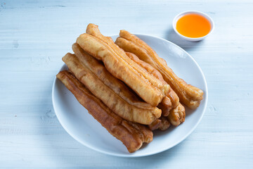 Youtiao or Yu Char Kway or cakwe is a long golden-brown deep-fried strip of wheat flour dough of Chinese origin. Perfect for recipe, article, catalogue, commercial, or any cooking content.