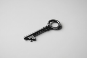 Vintage metal key on a plain surface