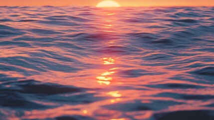 Fototapeta premium A close-up shot of the sea, lit by the golden rays of a setting sun.