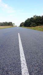 asphalt road without people in the plain and it seems to have no end
