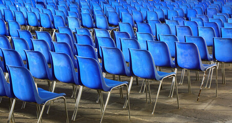 empty blue chairs without people before the start of a live concert