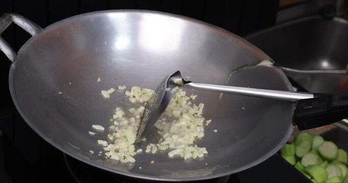 The housekeeper takes charge in the kitchen, expertly whipping up a delectable stir-fried zucchini dish with eggs and shrimp for the entire family's dinner.