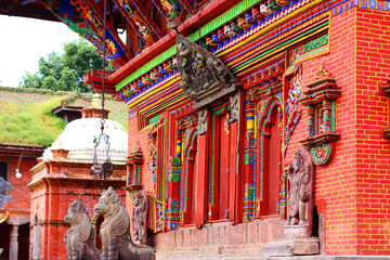 Changu Narayan Temple close-up showcasing intricate wooden carvings, colorful deities, and...