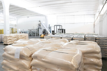 Stacks with sacks and bags with packages  full of grain ready to be transported. Images from inside an industrial grain mill. © DIA