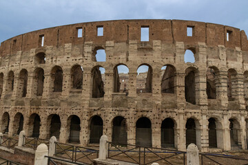 Roman Colosseum, the largest ancient amphitheatre ever built, Italy. Arches, exterior facade. ...