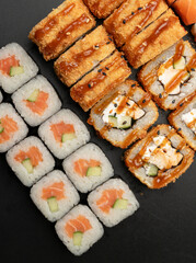 Set of sushi rolls on a black background