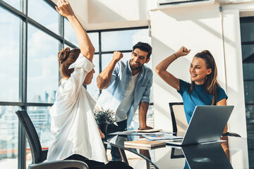 Group of happy businesspeople celebrate their successful project. Professional business team win and proud of their project at modern office. Successful teamwork, happy colleague, workplace. Tracery.