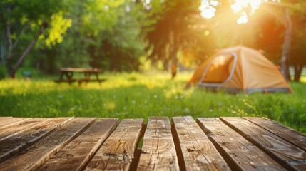 Wooden table top with blurred camping tent, grass field. Fresh and Relaxation theme for product display or visual layout with copy space.