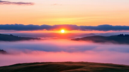 Obraz premium Sunrise breaking through morning fog over rolling hills, foggy weather, peaceful dawn