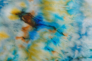 abstract pattern on silk fabric texture in blue, yellow, green colors