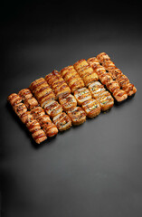 Set of fried rolls on a black background