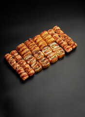 Set of fried rolls on a black background
