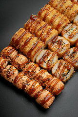 Set of fried rolls on a black background