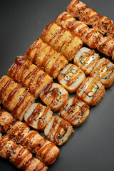 Set of fried rolls on a black background
