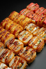 Set of fried rolls on a black background