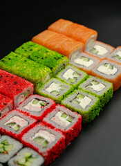 Set of sushi rolls on a black background