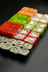 Set of sushi rolls on a black background