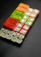 Set of sushi rolls on a black background
