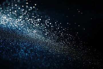sparkling blue glitter on dark backdrop with bokeh effect