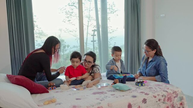 video of family playing in bed
