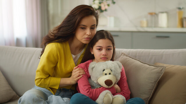 Worried Caucasian parent woman feel guilty female mother apologizing ask forgiveness little girl after quarrel argument calming sad child hugging saying sorry to crying kid daughter indoor living room
