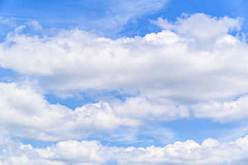 Fototapeta premium White clouds in a bright blue sky. The beauty of the nature