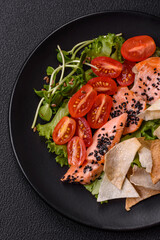 Delicious fresh caesar salad with salmon, lettuce, tomatoes and egg