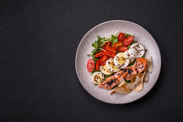 Delicious fresh caesar salad with salmon, lettuce, tomatoes and egg