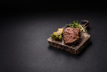 Bowl with slices of baked tuna with broccoli, tomatoes and fusili pasta