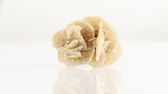 Desert roses mineral stone spinning in a circle on a white background