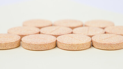 orange pills on white background