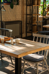 The aesthetic COZY appearance of an empty cafe with wooden furniture and minimalism.