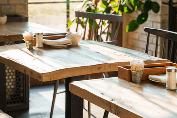 The aesthetic COZY appearance of an empty cafe with wooden furniture and minimalism.