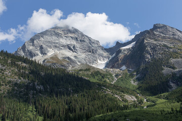 Fototapeta premium Majestic Mountain Peak with Forested Slopes